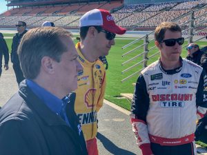 Joey Logano, Brad Keselowski and crew chief Todd Gordon gather at the Team Penske pit crew competition at Charlotte Motor Speedway.